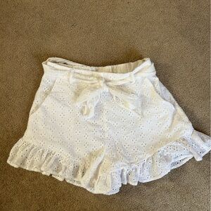 Woman’s size small white eyelet ruffled shorts.
